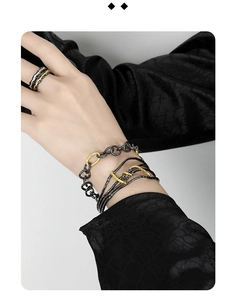 Detailed view of S925 sterling silver OT buckle bracelet and textured ring in gold and black