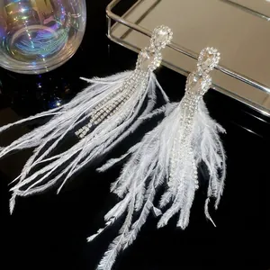 Elegant silver tassel earrings with white feathers and sparkling crystal rhinestones