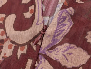 Detailed close-up of a hidden zipper on a bohemian paisley print chiffon dress