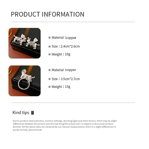 Detailed view of dog-shaped earrings and ring set in copper with white zircons