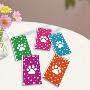 Set of five colorful paw print coil notebooks in green, pink, blue, purple, and orange