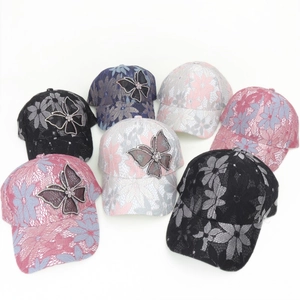 Detailed close-up of lace mesh baseball caps featuring sparkling butterfly rhinestone accents