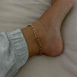 Detailed close-up of 4mm 14K gold plated Figaro link anklet worn on the ankle