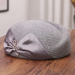 Elegant grey wool pillbox hat with mesh veil and satin bow for women in retro style
