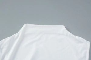 Close-up of white off-shoulder neckline with elegant pleats and smooth fabric texture