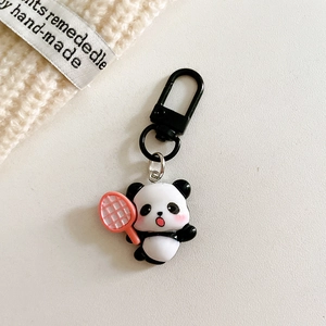 Close-up of cute panda keychain with pink tennis racket and black matte metal hook