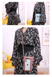 Detail of crossbody phone bag with transparent touchscreen window and metal turn lock