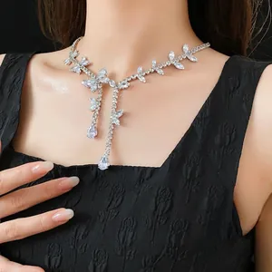 Silver butterfly necklace with teardrop zircons on a model in black clothing