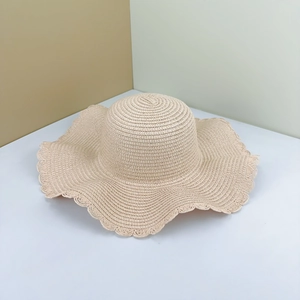 DIY beige wide-brim straw hat with wavy edges for sun protection and beach use