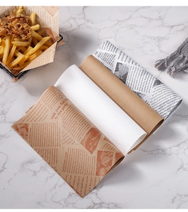 Greaseproof food wrapping paper with vintage newspaper pattern on marble tabletop background