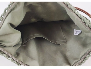Detail view of woven paper bag interior with zipper closure and material content label
