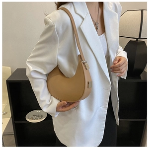 French style caramel hobo bag shown on model with adjustable metallic buckles