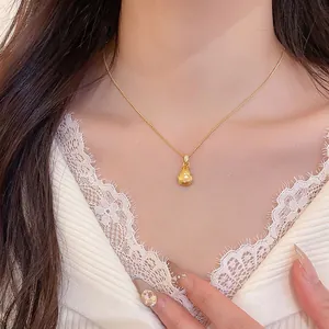 Retro style zircon lucky bag pendant necklace in gold finish on a female model