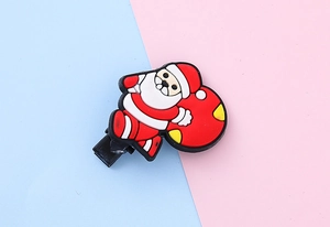 Detailed top view of a cartoon Santa Claus hair clip made of soft rubber on a metal base