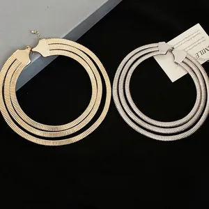Three-layer spring-style layered necklace in gold and silver finish on black fabric