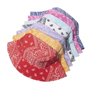 Multiple colorful paisley print bucket hats neatly stacked showing fabric detail and patterns