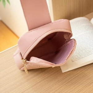 Pink quilted crossbody bag for women with golden hardware shown open in a lifestyle setting