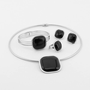 Detailed view of silver titanium jewelry set with black square stones and snake chain