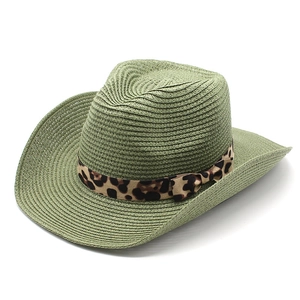 Detail of sage green straw cowboy hat featuring a leopard print ribbon bow decoration