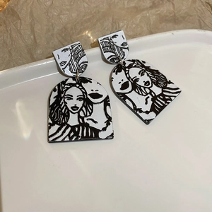 Detail shot of silver pin earrings with abstract minimal female portrait art illustration