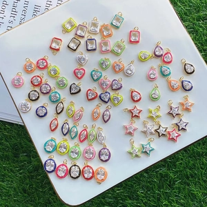 Colorful enamel geometric jewelry pendants with cubic zirconia on a white display tray