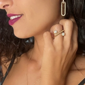 Gold stainless steel zircon ring and jewelry set worn on hand by a fashion model