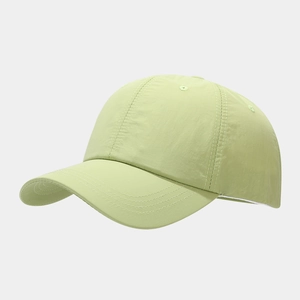 Close-up of light green quick-dry baseball cap featuring reinforced brim stitching