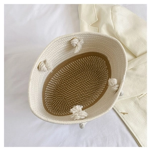 Top view of hand-woven cotton rope tote bag in cream and brown with knotted handles