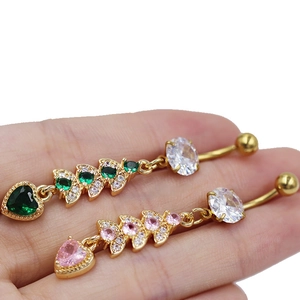 Detailed close-up of hollow heart navel rings with gold plating and colorful zircons