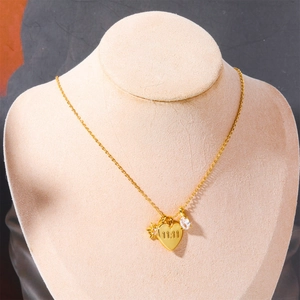Golden necklace with heart pendant engraved 11:11, star and zircon charms on jewelry bust