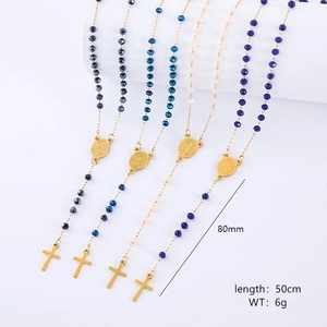 Detail of vintage beaded stainless steel necklaces with gold chains and religious medals