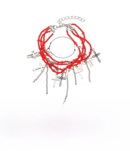 Detail of red beaded multilayer bracelet set with silver alloy cross charms and lobster clasp
