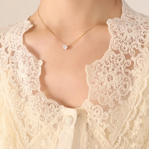 Elegant 18K gold-plated titanium necklace with a single round diamond on female model