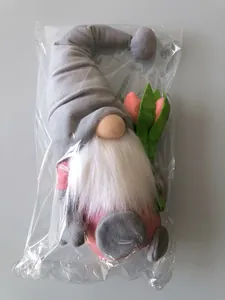 Detail of tulip gnome plush toy in transparent plastic bag on a cardboard box