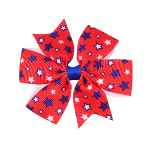 Close-up of red grosgrain bow hair clip with blue and white stars for Independence Day