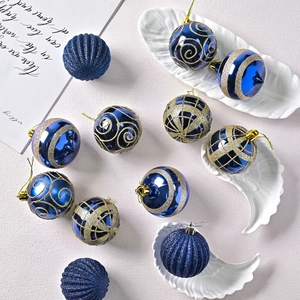 Blue and gold 6cm Christmas ball set with glitter patterns on a white textured background