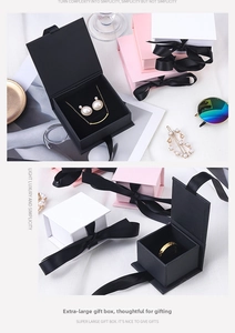Detail view of large jewelry gift boxes with ribbon bows in pink, white and black colors