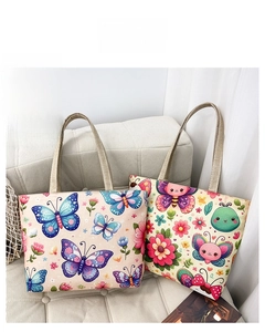 Detail showing two floral canvas tote bags with colorful butterfly prints and wide straps