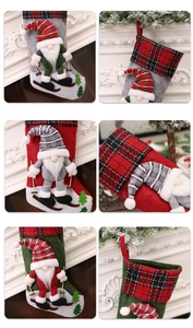 Detail of Christmas gnome stockings with wooden ski poles on festive mantle background