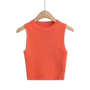 Vibrant orange Y2K cropped knitted vest in stretchy ribbed fabric on a hanger