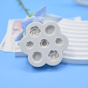 Detail of 7-cavity white silicone rose petal fondant mold on a rippled display stand