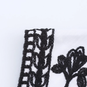 Ethnic style loose vest for women with intricate black embroidery on white fabric