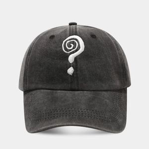 Close-up of white question mark embroidery on washed cotton baseball cap with vintage finish