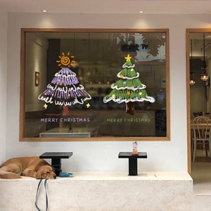 Christmas tree window decals in purple and green for holiday store decoration with golden retriever