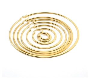 Detailed set of six gold-plated stainless steel hoop earrings in various sizes on white