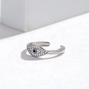 Detailed view of silver evil eye open ring with blue stone and micro pavé stones