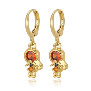 Detail of copper girl earrings with red zircon stones and gold finish