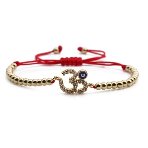 Adjustable evil eye charm bracelet with golden beads and red braided cord for women