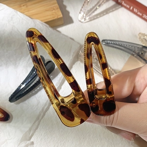 Close-up of leopard print acrylic triangle hair clip with retro amber texture