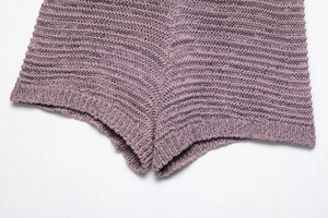 Detailed close-up showing texture and stitching of purple knit shorts for women